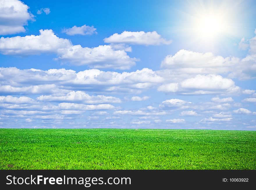Summer field with green grass and blue sky with clouds. Summer field with green grass and blue sky with clouds