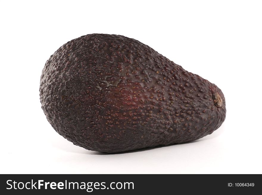 A picture of a single avocado isolated against a white background