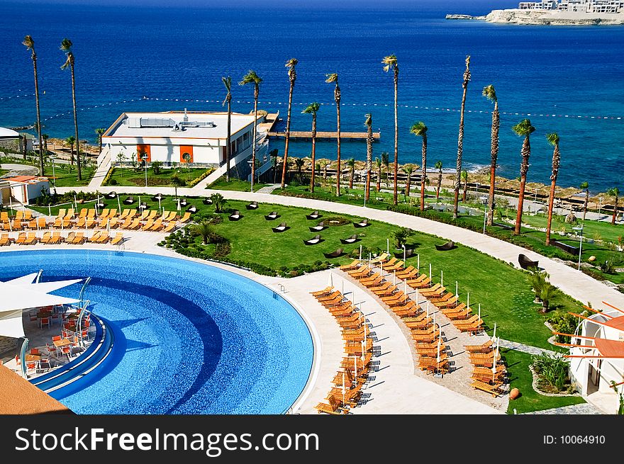 Sunbeds and umbrellas near resort's pool. Sunbeds and umbrellas near resort's pool