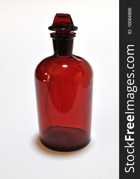 Photograph of isolated classic red laboratory reagent bottle. Photograph of isolated classic red laboratory reagent bottle