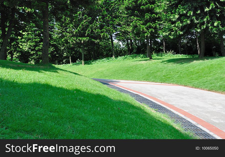 Path in garden around green tree and grass under sun shine. Guangzhou, Southen China. Path in garden around green tree and grass under sun shine. Guangzhou, Southen China.