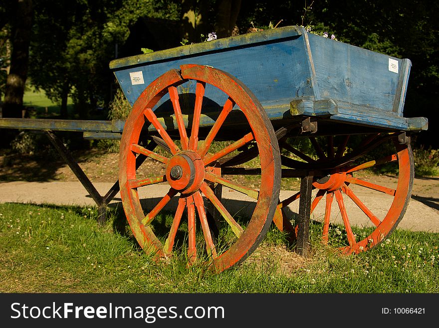 Old horse cart resting in a field.