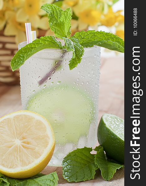 Close up shot of ice cold drink with lime and lemon