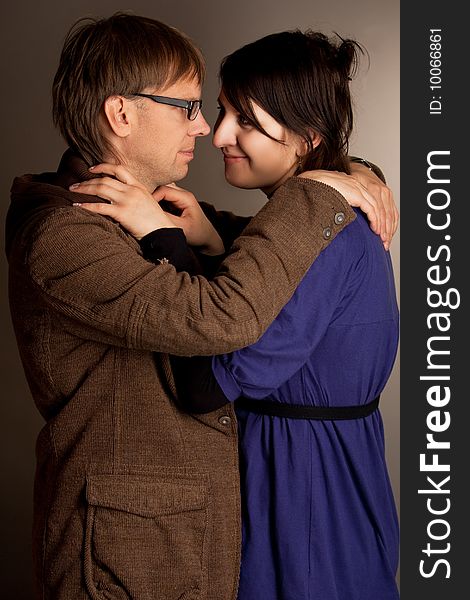 Couple standing together with smile isolated over gray