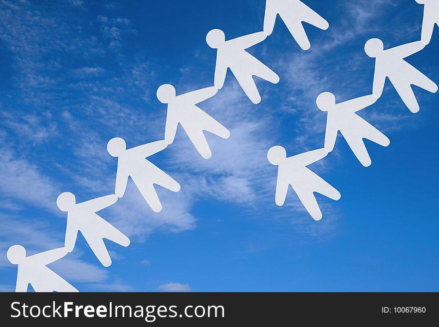 The image of silhouettes of the people keeping for hands on a background of the sky. The image of silhouettes of the people keeping for hands on a background of the sky.