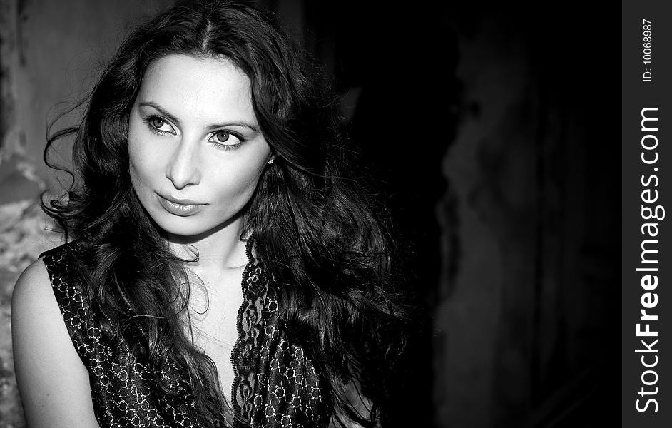 Expressive portrait of young woman on old wall background