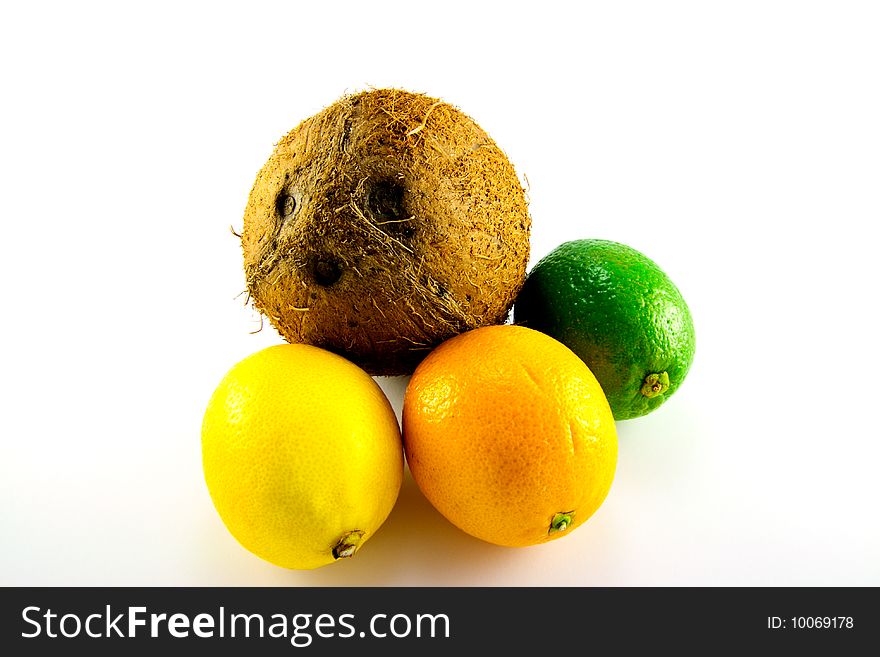 Single whole lemon, lime, orange and coconut with a white background