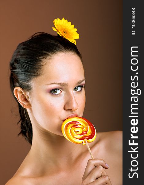 Smiling woman with a lollipop
