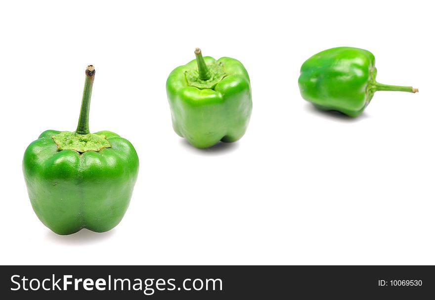 Green capsicums isolated on white background.