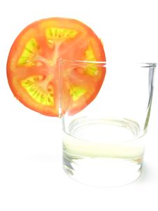 Glass Of Sunflower Oil And Tomatoes. Stock Photo Glass Of Sunflower Oil And Tomatoes. Stock Photo