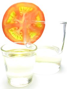 Glass Of Sunflower Oil And Tomatoes. Stock Photography Glass Of Sunflower Oil And Tomatoes. Stock Photography