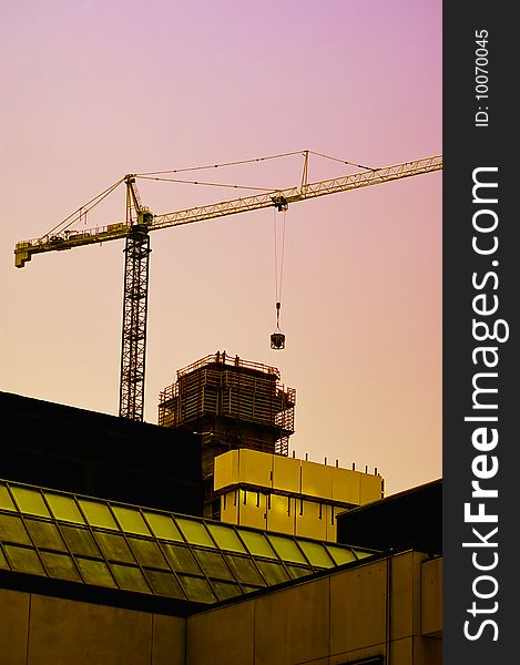 Sunset on a construction site, people working