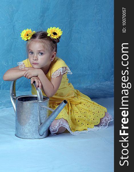 The girl with a watering can on a blue background