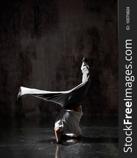 Modern style dancer posing on dirty grunge background. Modern style dancer posing on dirty grunge background