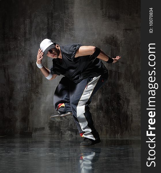 Modern style dancer posing on dirty grunge background. Modern style dancer posing on dirty grunge background