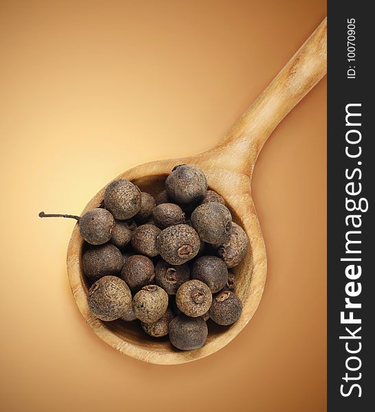 Aromatic pepper in wooden spoon