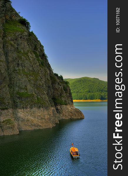 Peaceful boat tour on an artificial mountain lake. Peaceful boat tour on an artificial mountain lake