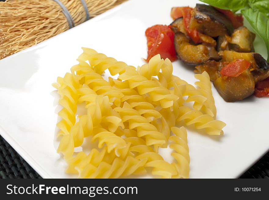 Italian pasta with aubergines, tomatoes and basil. Italian pasta with aubergines, tomatoes and basil