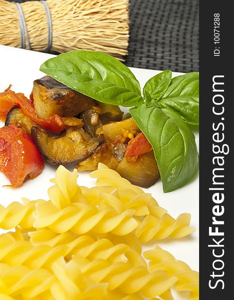 Italian pasta with aubergines, tomatoes and basil. Italian pasta with aubergines, tomatoes and basil