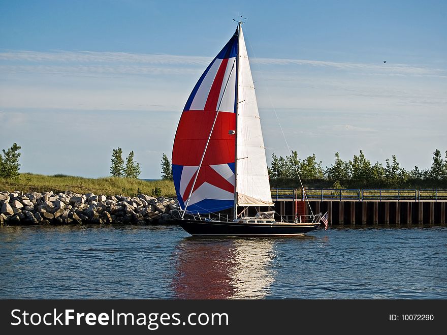 Sailboat in a harbor waterway. Sailboat in a harbor waterway.