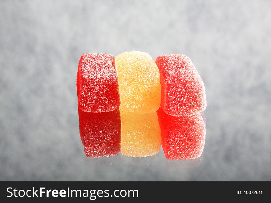 Three jelly-candies, against the gray background