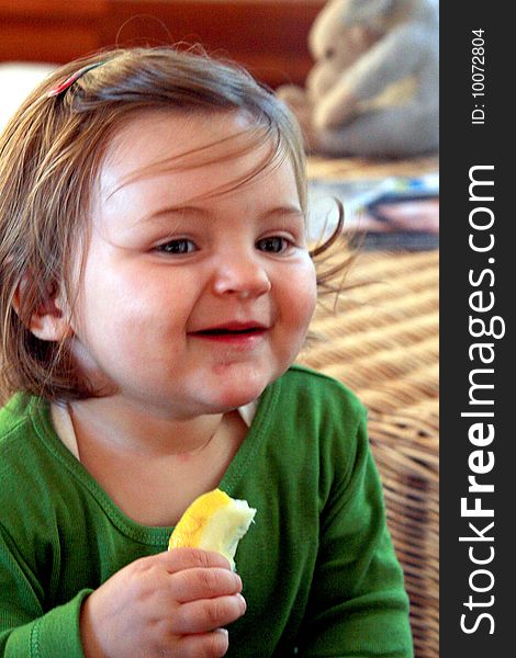 Adorable 14 month old holding a piece of lemon. Adorable 14 month old holding a piece of lemon