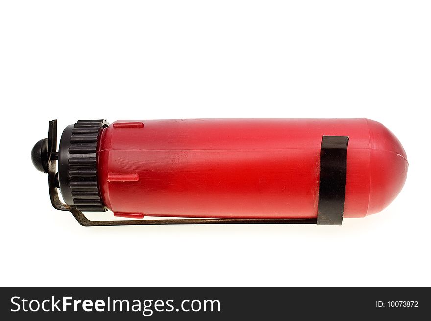 The red automobile fire extinguisher is isolated on a white background