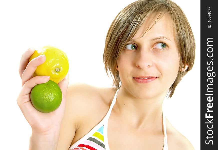 Portrait of a cute young Caucasian blond lady with a nice colorful striped summer dress who is smiling and she is holding a fresh lemon and a lime in her hand. Isolated on white. Portrait of a cute young Caucasian blond lady with a nice colorful striped summer dress who is smiling and she is holding a fresh lemon and a lime in her hand. Isolated on white.