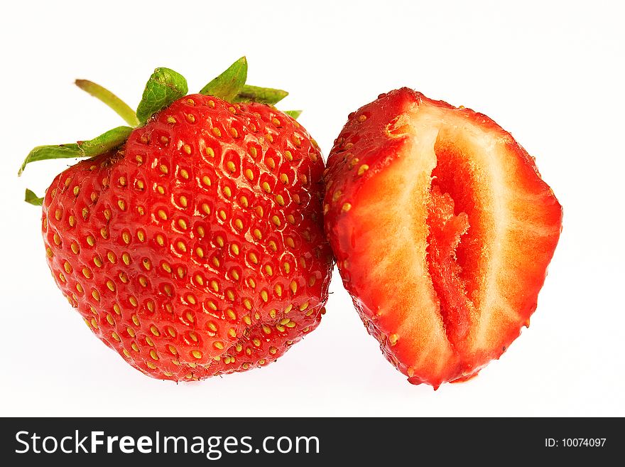 Macro shot fresh strawberry and a half over white background