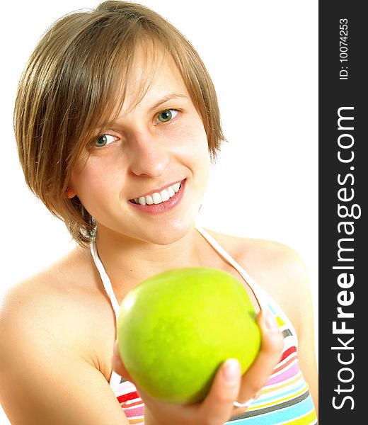 Portrait of an attractive Caucasian blond girl with a nice colorful striped dress who is smiling and she is holding a green apple in her hand. Isolated on white. Portrait of an attractive Caucasian blond girl with a nice colorful striped dress who is smiling and she is holding a green apple in her hand. Isolated on white.