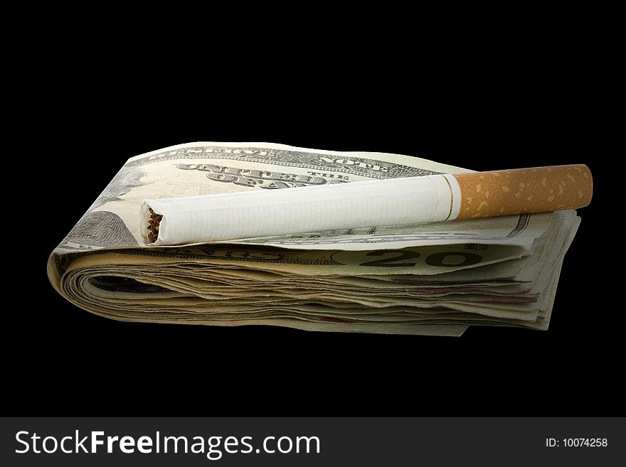 Cigarette on a money stack with black background. Cigarette on a money stack with black background