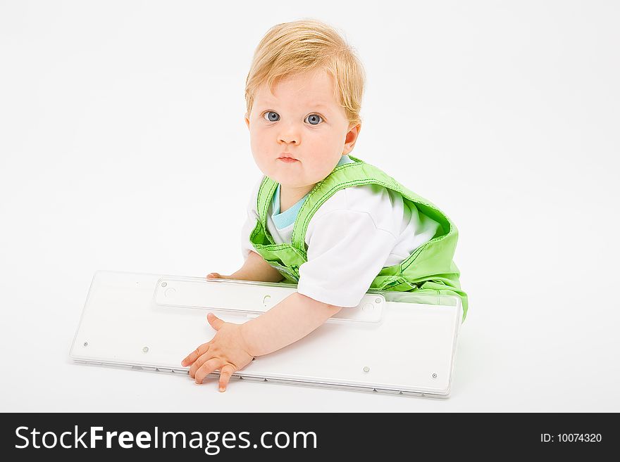 Baby boy play with white computer keyboard. Baby boy play with white computer keyboard