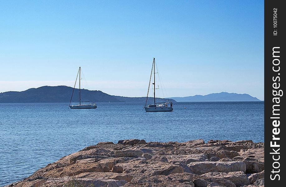 Two yachts swiming in a the blue water of the mediteranean sea. Two yachts swiming in a the blue water of the mediteranean sea