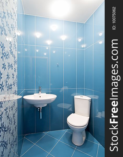 Interior of a new toilet room in blue colors