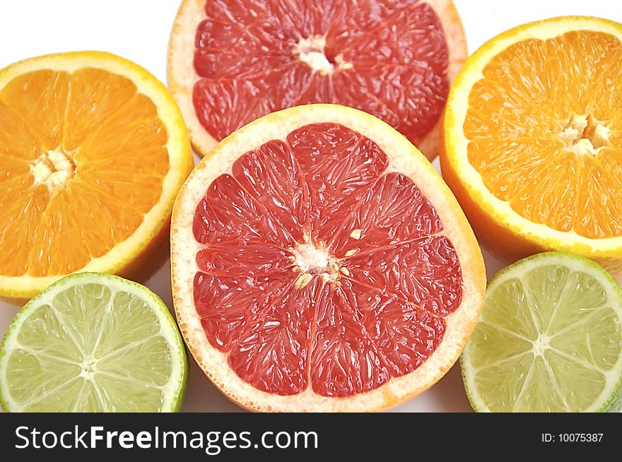 Background of cut grapefruit, orange and lime.