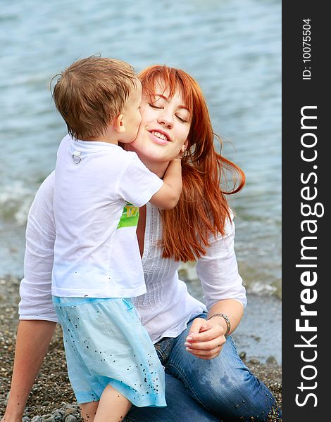 Mother and son playing on beach. Mother and son playing on beach