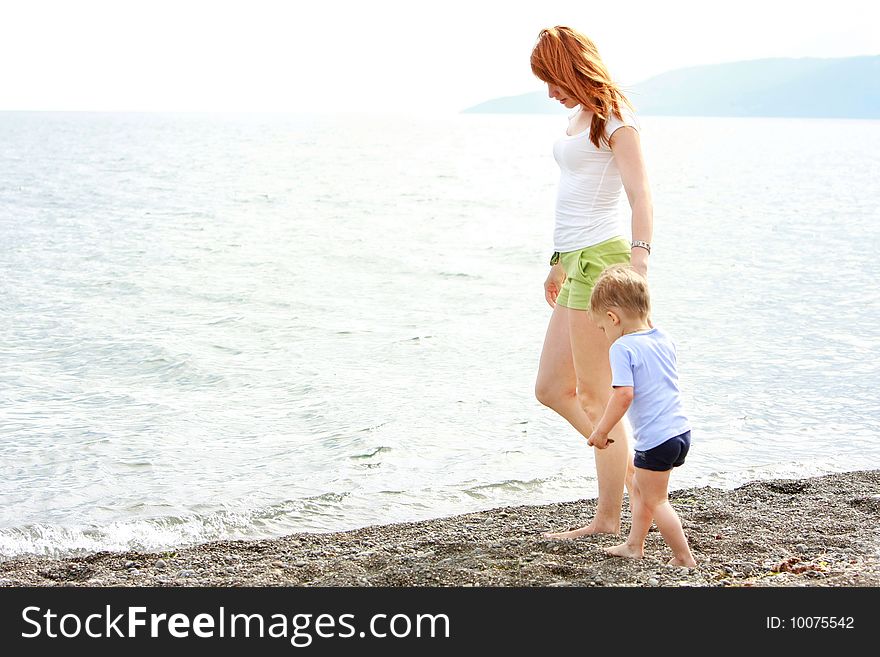 Mother and son playing on beach. Mother and son playing on beach