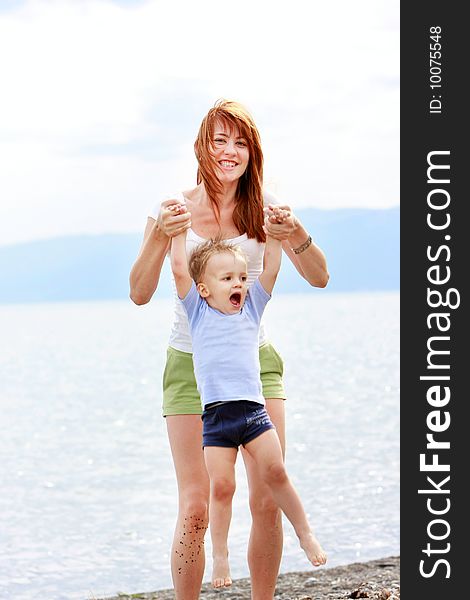 Mother and son playing on beach. Mother and son playing on beach