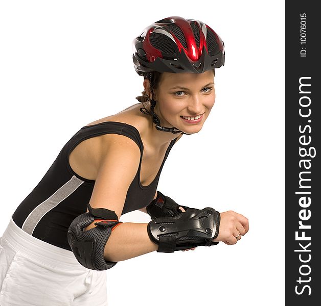 Funny young woman in a sport helmet and in a tracksuit go rollerblades. Funny young woman in a sport helmet and in a tracksuit go rollerblades