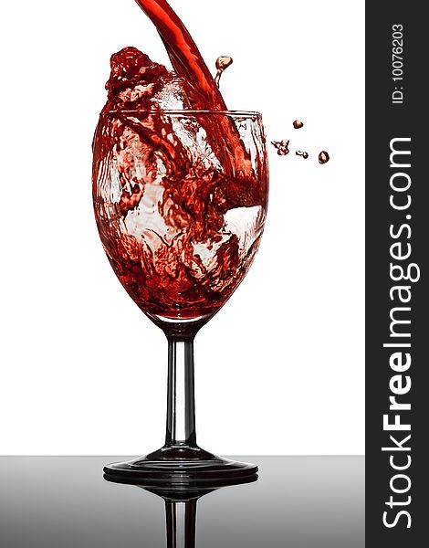 Wine splash in glass with white background