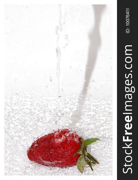 Pouring water over strawberry on white background. Pouring water over strawberry on white background