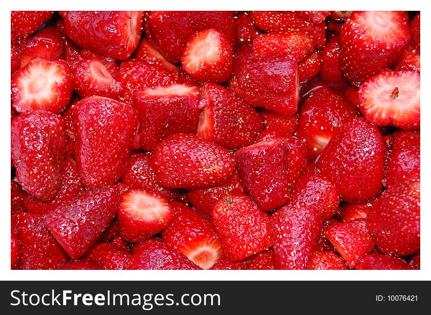 A batch of fresh-cut strawberries. A batch of fresh-cut strawberries