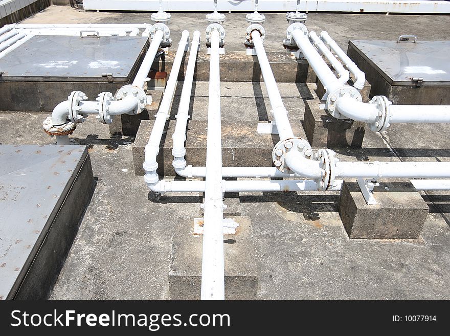 Assorted pipelines on the concrete roof of a building. Assorted pipelines on the concrete roof of a building.