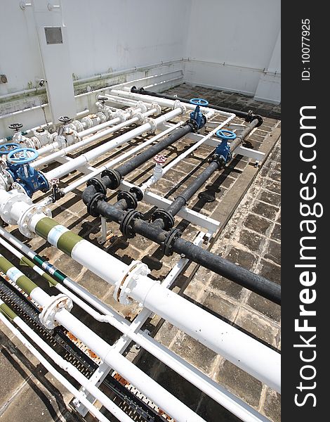 Assorted pipelines on the concrete roof of a building. Assorted pipelines on the concrete roof of a building.