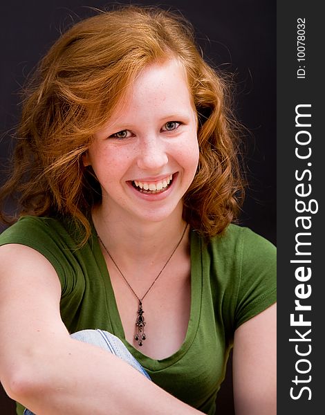 Beautiful freckled teen girl smiling with red hair