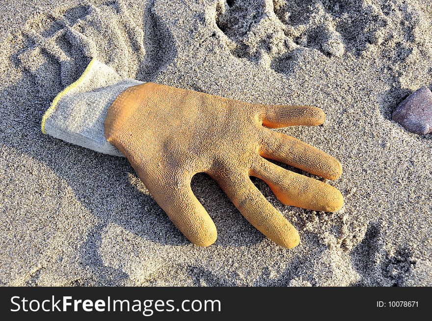 A washed up glove on a beach