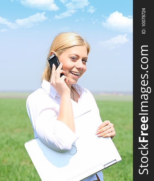 Picture of happy businesswoman with laptop computer, talks by phone