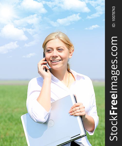 Picture of happy businesswoman with laptop computer, talks by phone