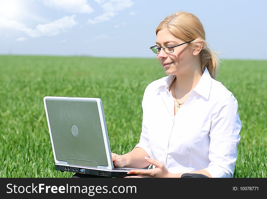 Business lady typing on laptop, sitting outdoors. Business lady typing on laptop, sitting outdoors.
