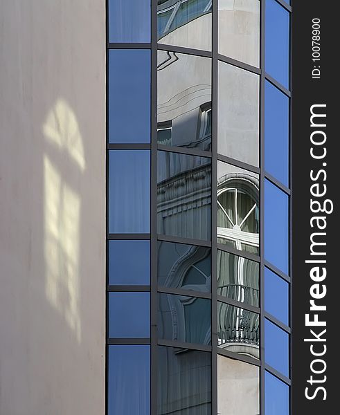 The modern office block is the old house's malformed image on his windows. The modern office block is the old house's malformed image on his windows.